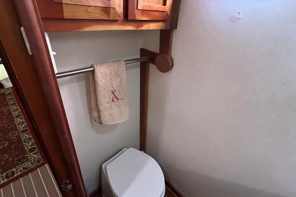Island Hopper Yacht Photos Pics Bathroom interior of 2001 Crosswater Passagemaker 49 yacht, featuring a towel rack and toilet.