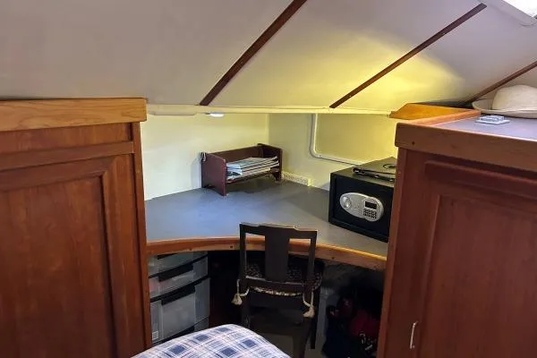 Island Hopper Yacht Photos Pics Cozy interior of 2001 Crosswater Passagemaker 49 with wooden cabinets and compact workspace.