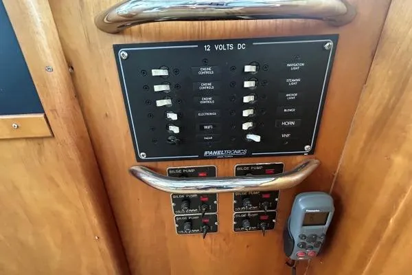Island Hopper Yacht Photos Pics Electrical control panel on 2001 Crosswater Passagemaker 49 boat, featuring switches and bilge pump controls.
