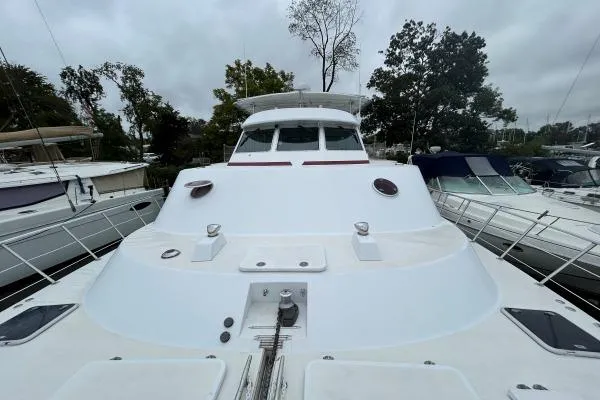 Island Hopper Yacht Photos Pics 2001 Crosswater Passagemaker 49 yacht docked, showcasing sleek design and spacious deck.