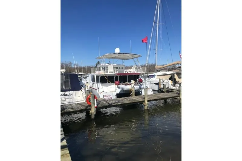Island Hopper Yacht Photos Pics Crosswater Passagemaker 49 yacht docked at marina, 2001 model, clear blue sky.
