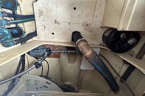 Island Hopper Yacht Photos Pics Engine room of 2001 Crosswater Passagemaker 49 with visible hoses and fittings.