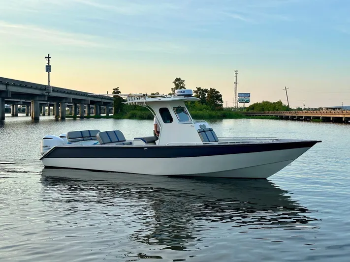  Yacht Photos Pics Custom 2003 Leblanc CC boat on calm water near a bridge at sunset.