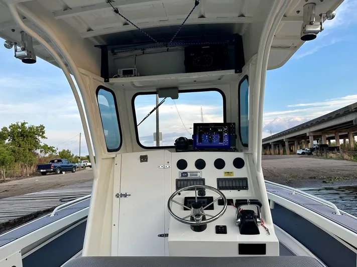  Yacht Photos Pics Interior view of a 2003 Custom Leblanc CC boat cockpit with steering wheel and controls.