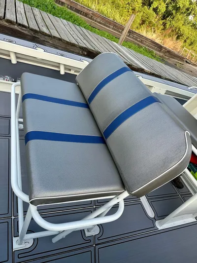  Yacht Photos Pics Custom Leblanc CC 2003 boat seat with blue stripes on a dock.