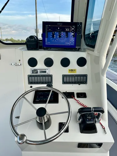  Yacht Photos Pics Boat dashboard of 2003 Custom Leblanc CC with steering wheel and navigation display.