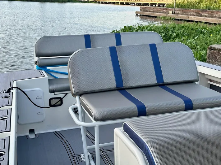  Yacht Photos Pics Custom 2003 Leblanc CC boat seats with blue-striped cushions by a serene lake.