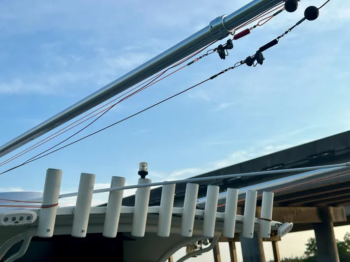  Yacht Photos Pics Custom 2003 Leblanc CC boat with rod holders and cables under a clear sky.