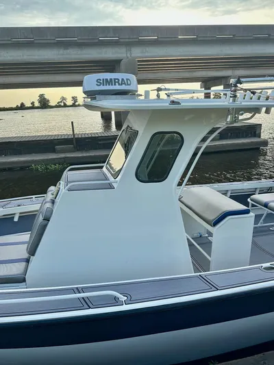  Yacht Photos Pics 2003 Custom Leblanc CC boat with Simrad equipment, docked under a bridge.