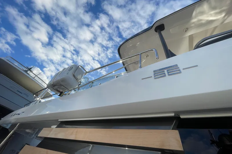 Azimut 66 Magellano Yacht Photos Pics 2024 Azimut Magellano 66 yacht against a blue sky with clouds.