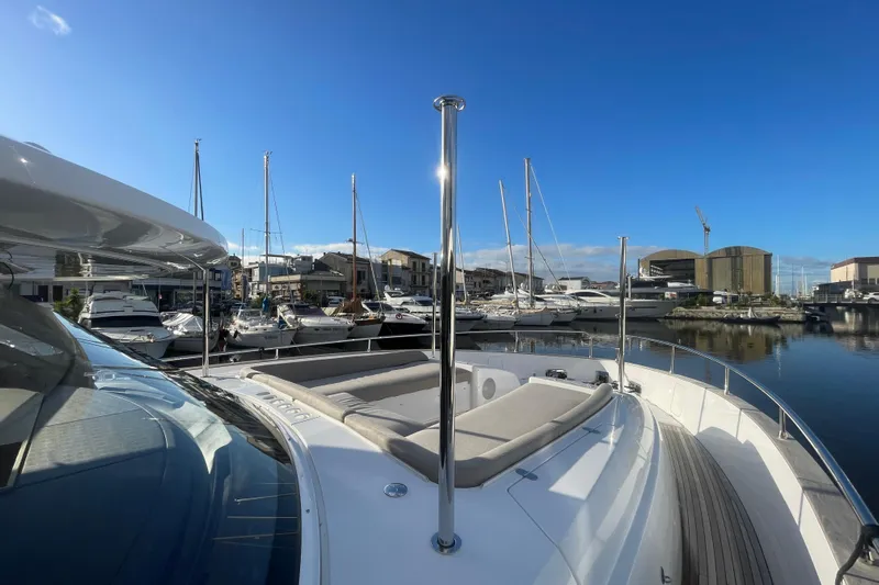 Azimut 66 Magellano Yacht Photos Pics 2024 Azimut Magellano 66 yacht docked in a marina under clear blue skies.