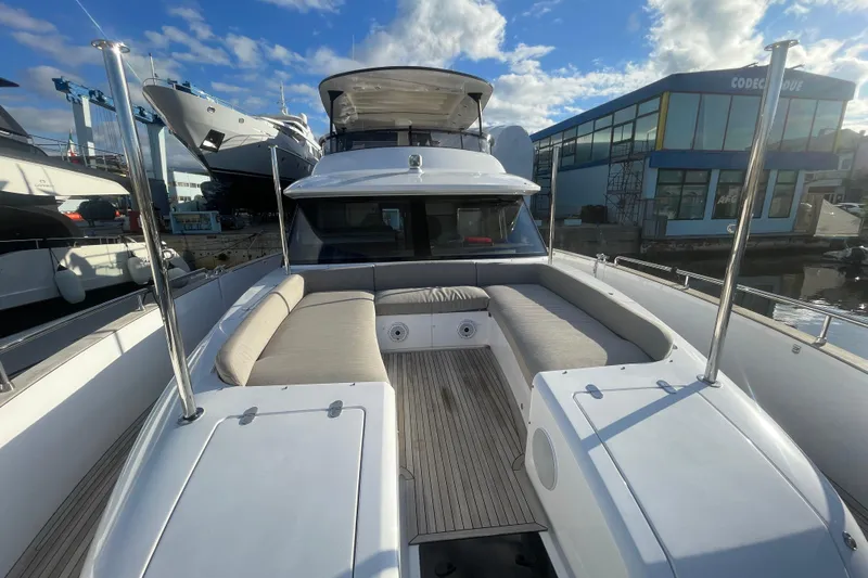 Azimut 66 Magellano Yacht Photos Pics Azimut Magellano 66 yacht, 2024 model, featuring spacious deck seating under a blue sky.