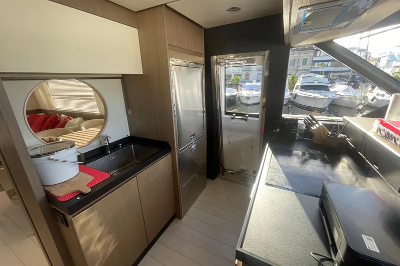 Azimut 66 Magellano Yacht Photos Pics Modern kitchen interior of 2024 Azimut Magellano 66 yacht, featuring sleek design and marina view.