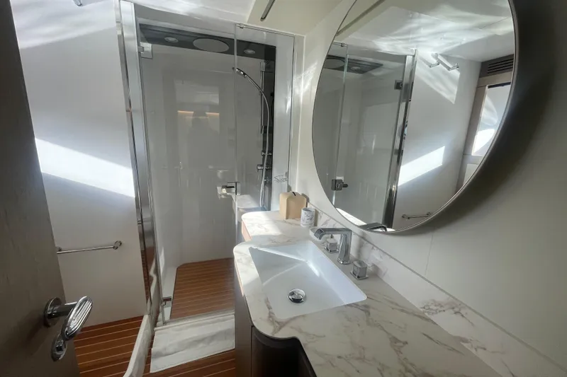 Azimut 66 Magellano Yacht Photos Pics Luxurious bathroom in 2024 Azimut Magellano 66 yacht with marble countertop and modern shower.
