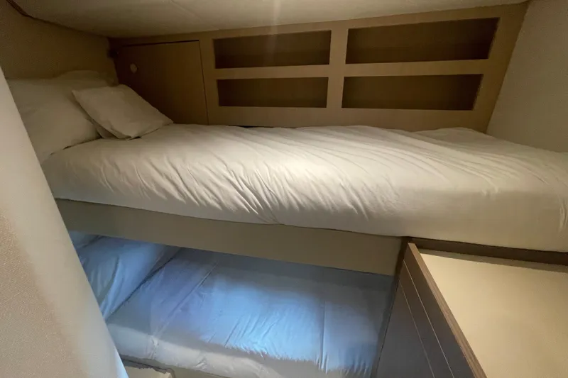Azimut 66 Magellano Yacht Photos Pics Bunk beds in 2024 Azimut Magellano 66 yacht cabin, featuring modern design and cozy bedding.