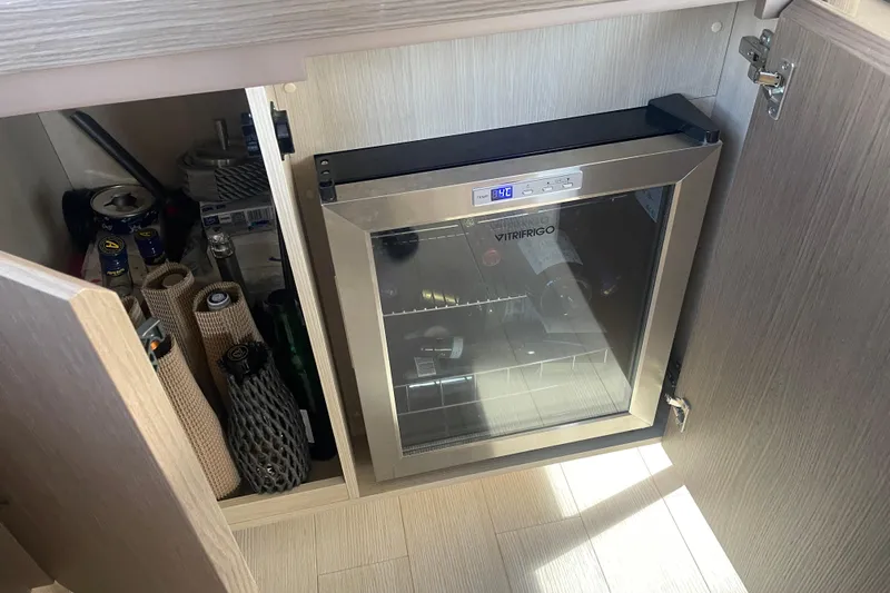 Azimut 66 Magellano Yacht Photos Pics Compact fridge in Azimut Magellano 66 yacht, 2024 model, with beverages and storage.