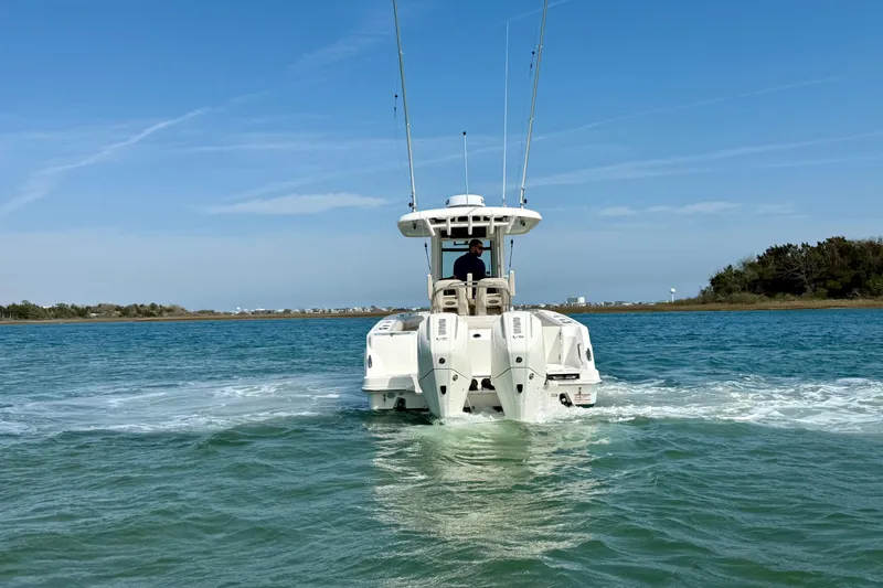  Yacht Photos Pics 2024 Boston Whaler 250 Outrage cruising on open water, showcasing powerful dual engines.