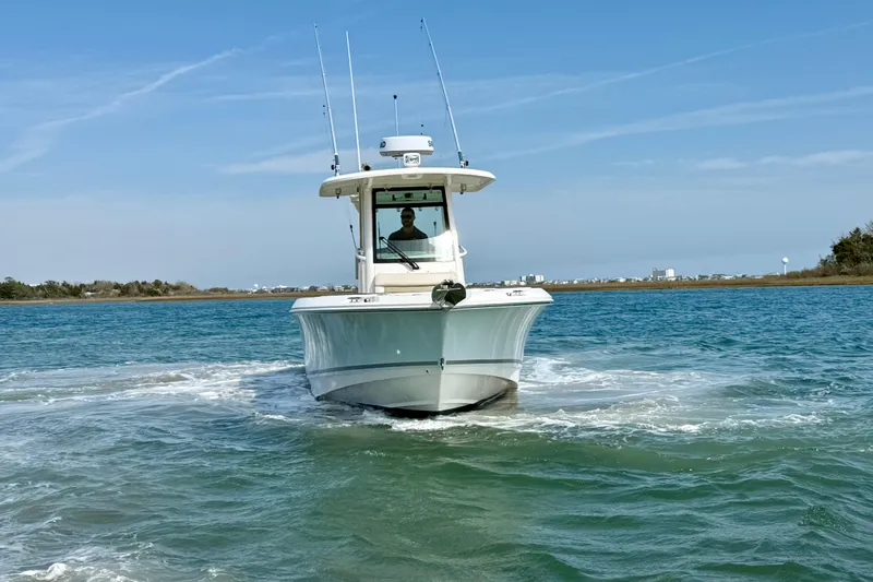  Yacht Photos Pics 2024 Boston Whaler 250 Outrage boat navigating clear blue waters.