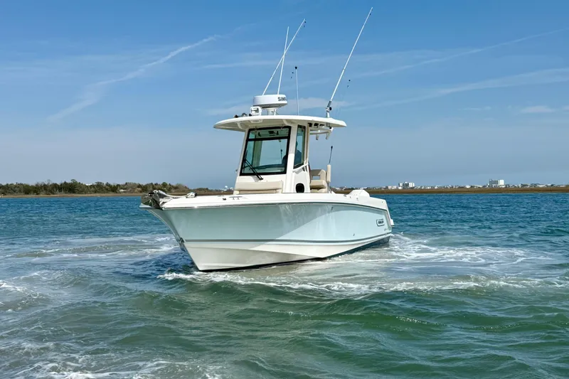  Yacht Photos Pics 2024 Boston Whaler 250 Outrage boat cruising on open water under clear skies.