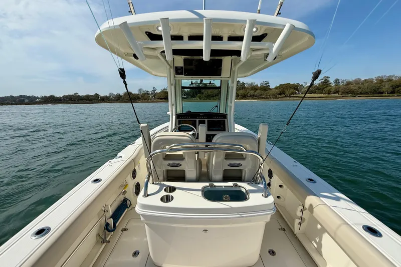  Yacht Photos Pics 2024 Boston Whaler 250 Outrage boat on water, featuring spacious deck and fishing equipment.