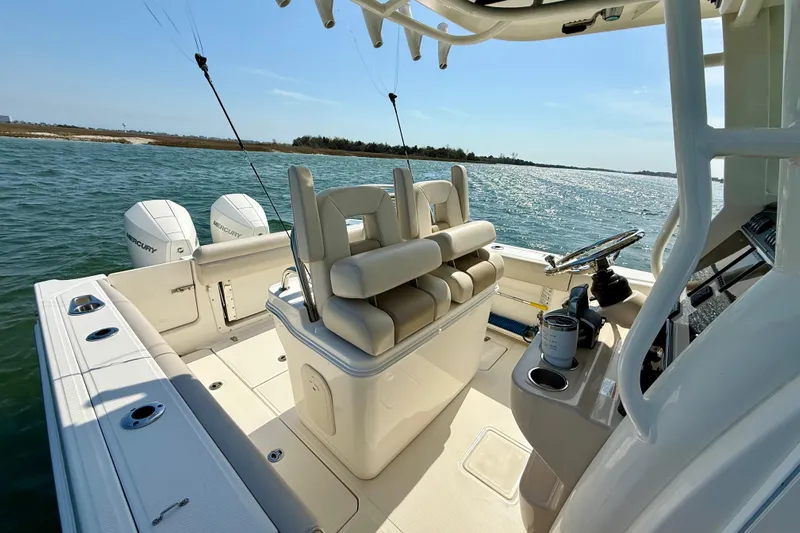  Yacht Photos Pics 2024 Boston Whaler 250 Outrage boat interior with dual Mercury engines on open water.