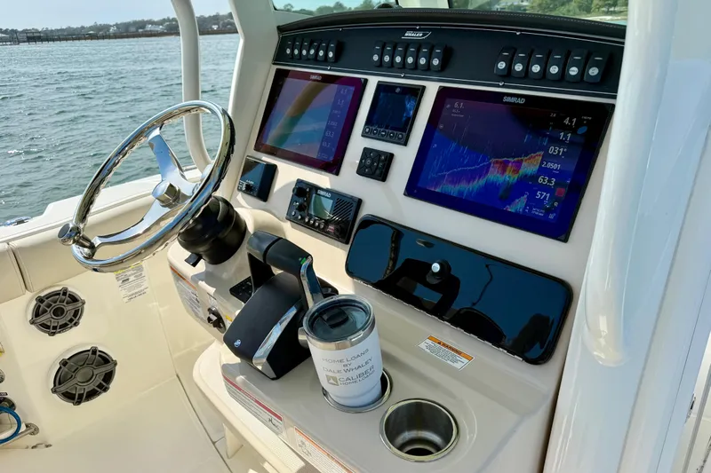  Yacht Photos Pics 2024 Boston Whaler 250 Outrage helm with advanced navigation displays and controls.