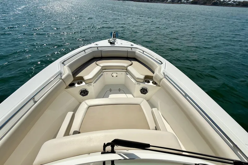 Yacht Photos Pics 2024 Boston Whaler 250 Outrage boat interior with cushioned seating on open water.
