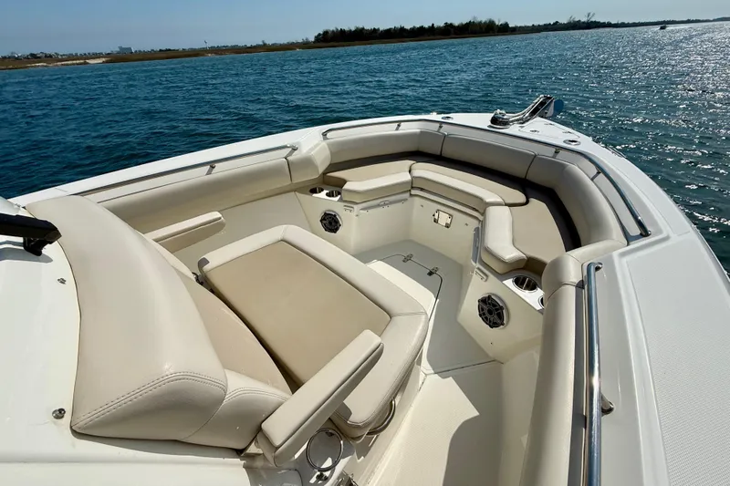 Yacht Photos Pics 2024 Boston Whaler 250 Outrage boat interior with cushioned seating on open water.
