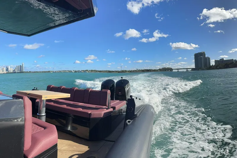  Yacht Photos Pics Luxurious 2024 Skipper 42 yacht cruising on a sunny day with city skyline views.