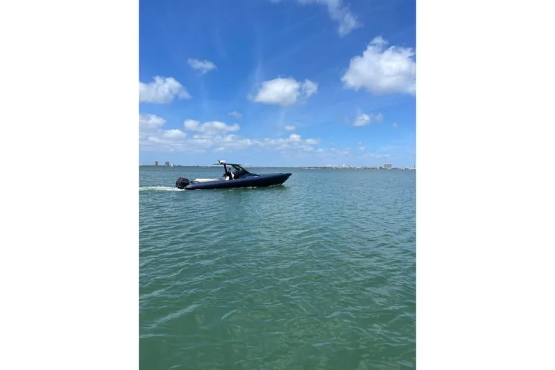  Yacht Photos Pics 2024 Skipper 42 boat cruising on a sunny day with blue skies and calm waters.