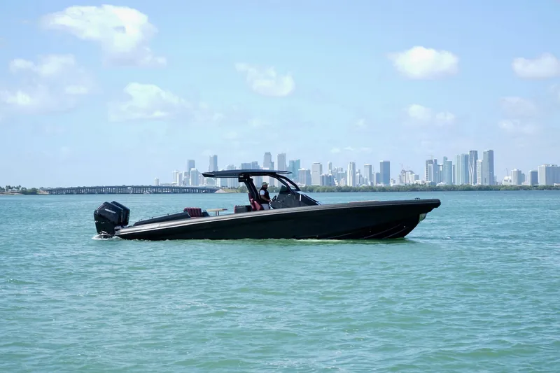  Yacht Photos Pics 2024 Skipper 42 boat cruising on water with city skyline in background.