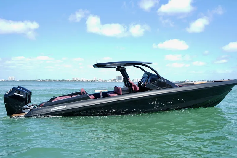  Yacht Photos Pics 2024 Skipper 42 boat cruising on clear blue waters under a sunny sky.