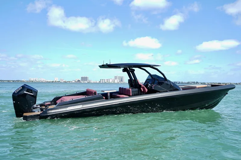  Yacht Photos Pics 2024 Skipper 42 boat on water, sleek design, sunny day, city skyline in background.