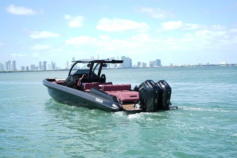  Yacht Photos Pics 2024 Skipper 42 boat cruising near city skyline on a sunny day.