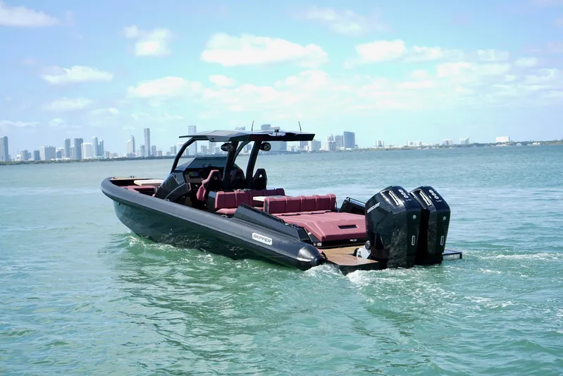  Yacht Photos Pics 2024 Skipper 42 boat cruising on water with city skyline in background.