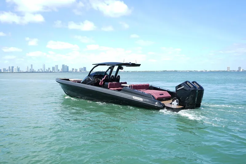  Yacht Photos Pics 2024 Skipper 42 boat cruising on open water with city skyline in background.