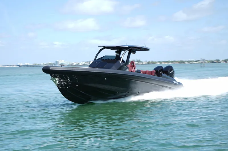  Yacht Photos Pics 2024 Skipper 42 speedboat cruising on clear blue water.