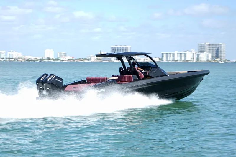  Yacht Photos Pics 2024 Skipper 42 speedboat cruising on water with city skyline in background.