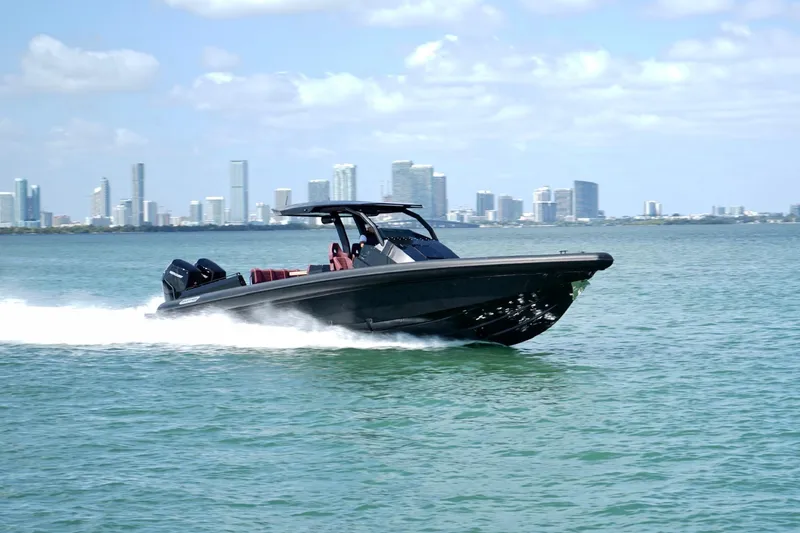  Yacht Photos Pics 2024 Skipper 42 boat cruising on water with city skyline in background.