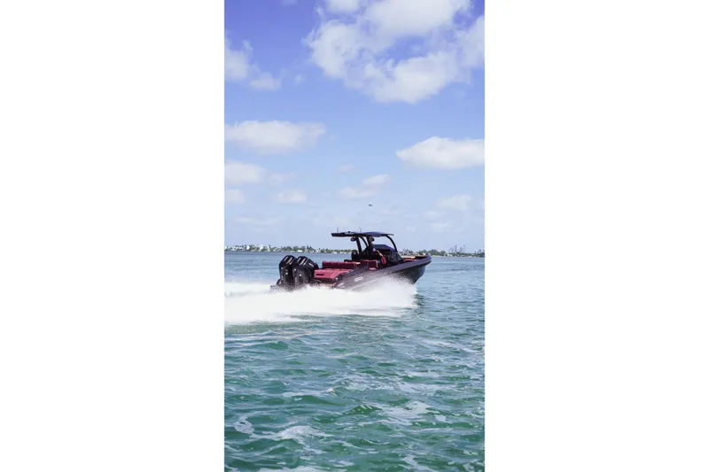  Yacht Photos Pics 2024 Skipper 42 boat cruising on open water under a clear blue sky.