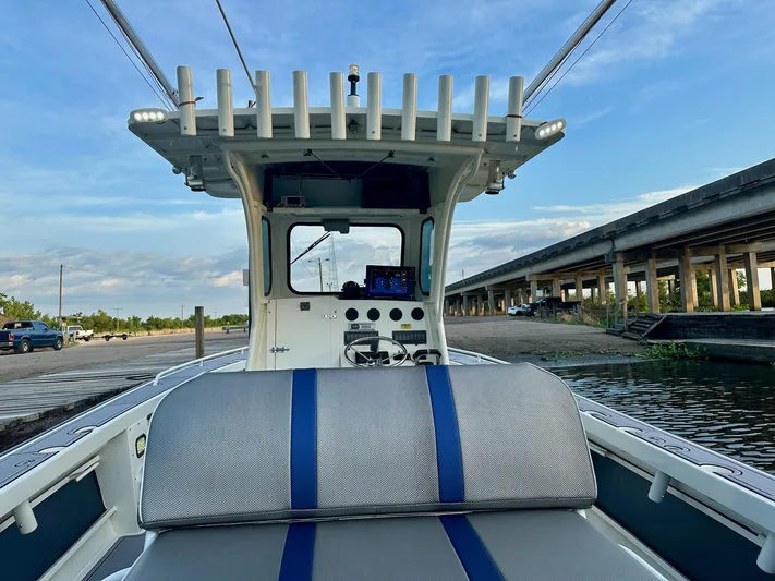  Yacht Photos Pics 2003 Custom Leblanc CC boat at dock, featuring a spacious deck and modern controls.