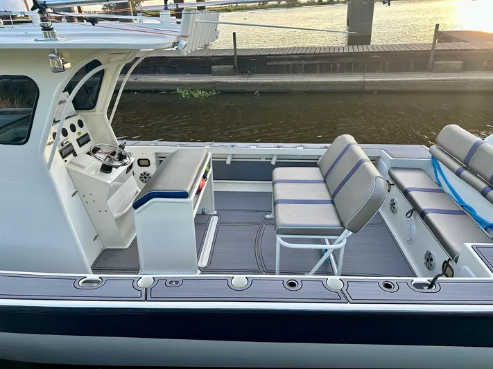  Yacht Photos Pics Custom 2003 Leblanc CC boat interior with seating and steering console, docked by the water.