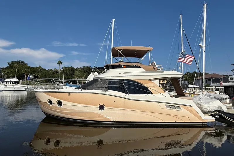Long Gone Yacht Photos Pics 2013 Carver C34 yacht docked in a marina, featuring sleek design and American flag.