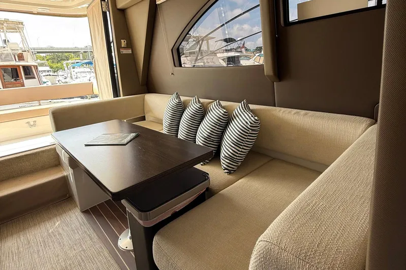 Long Gone Yacht Photos Pics Luxurious interior of 2013 Carver C34 yacht with cozy seating and striped pillows.