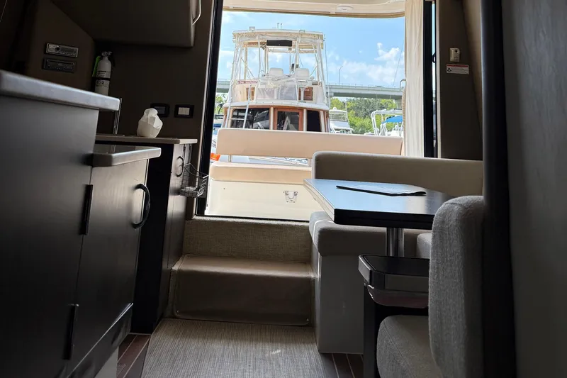 Long Gone Yacht Photos Pics Interior of 2013 Carver C34 yacht with dining area and view of docked boat.