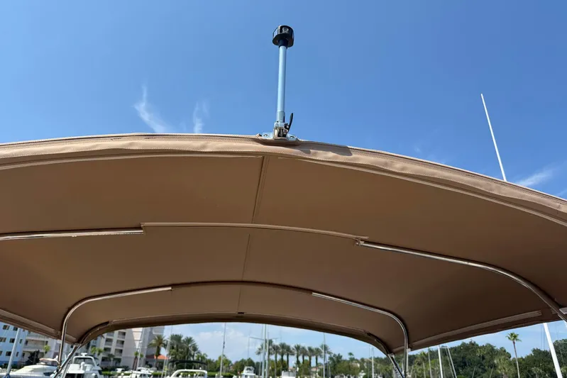 Long Gone Yacht Photos Pics 2013 Carver C34 boat canopy under clear blue sky.