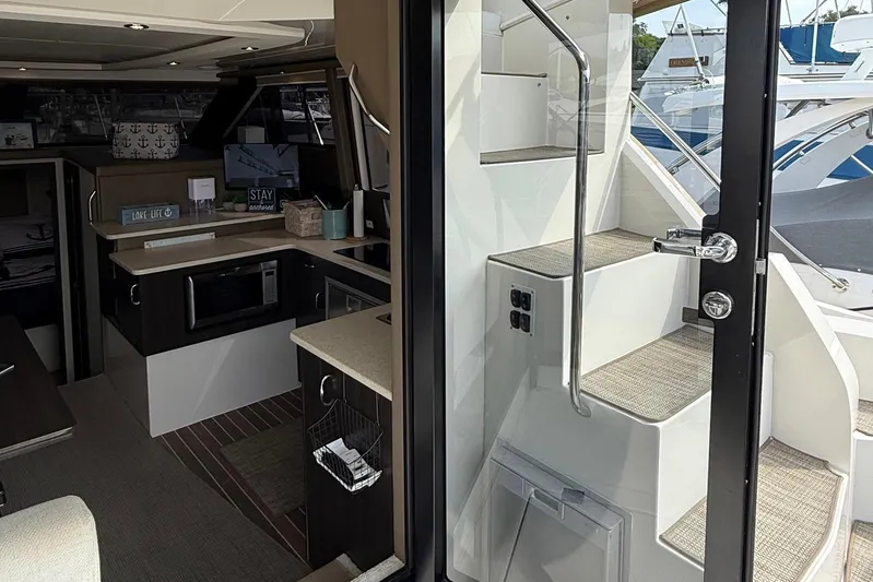 Long Gone Yacht Photos Pics Interior view of 2013 Carver C34 yacht, featuring modern kitchen and staircase.