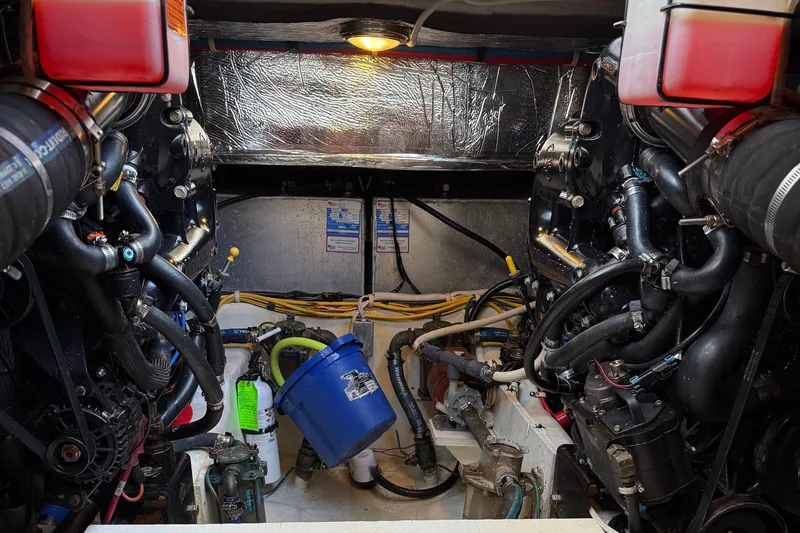 Long Gone Yacht Photos Pics Engine room of a 2013 Carver C34 boat, showcasing complex machinery and components.