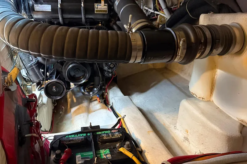Long Gone Yacht Photos Pics Engine compartment of a 2013 Carver C34 boat, featuring battery and mechanical components.