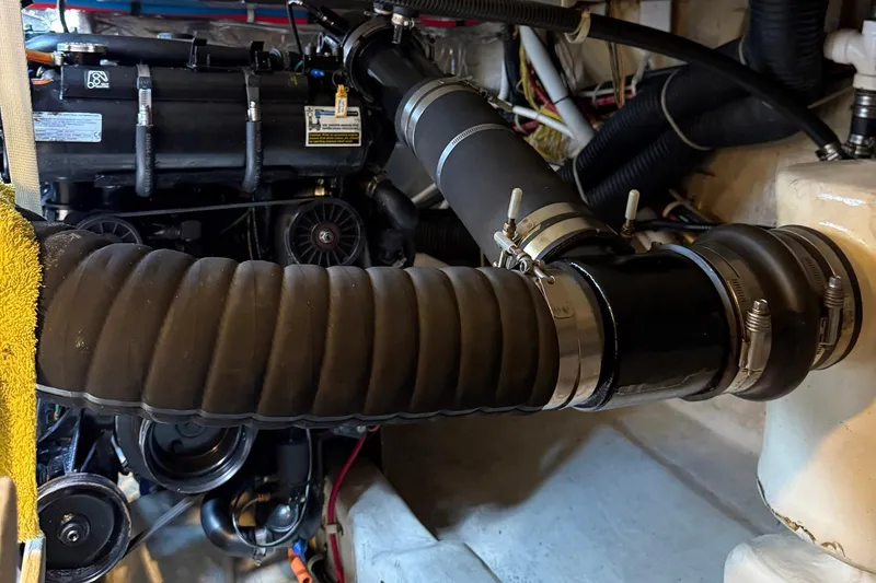 Long Gone Yacht Photos Pics Engine compartment of 2013 Carver C34 boat with hoses and mechanical components.